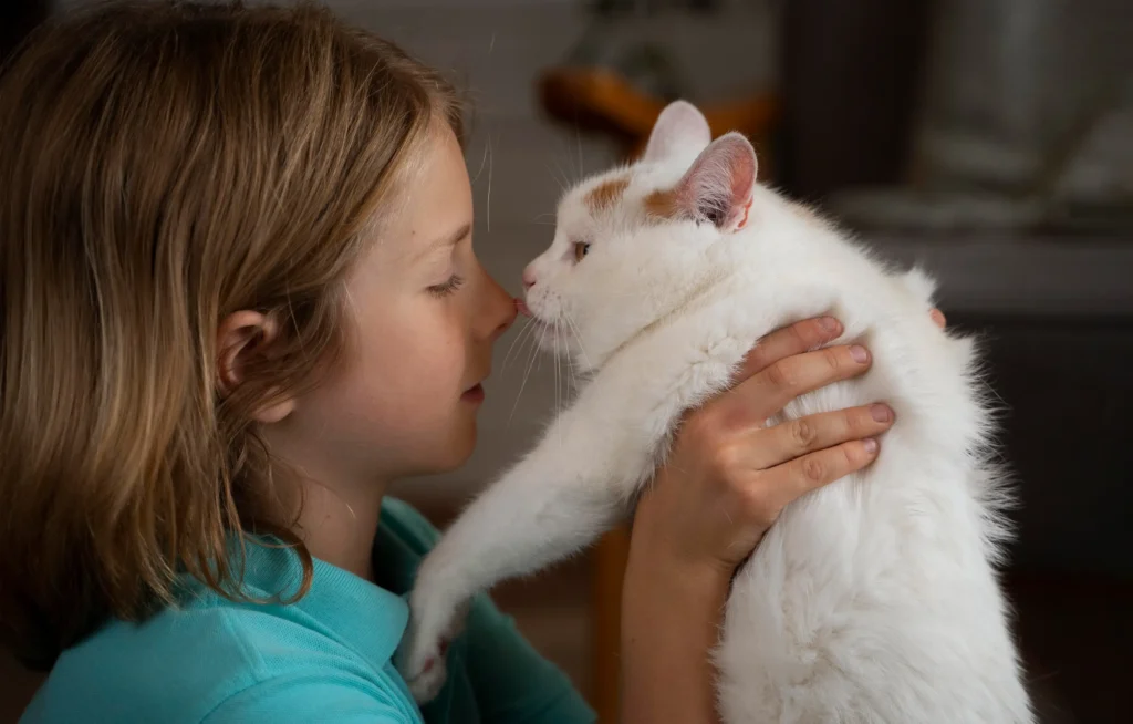 I hold my cat and it licks my nose